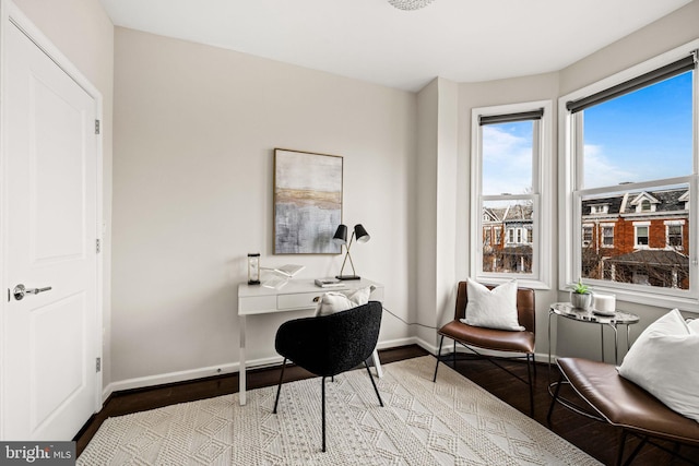 office space with baseboards and wood finished floors