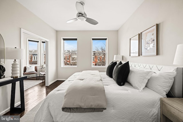 bedroom with access to exterior, dark wood-style flooring, a ceiling fan, and baseboards