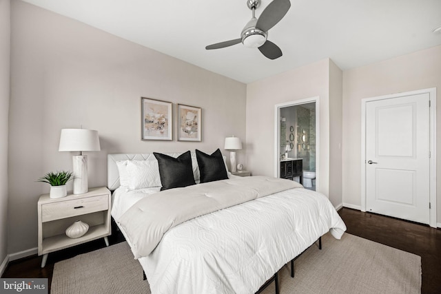 bedroom featuring ensuite bath, wood finished floors, a ceiling fan, and baseboards