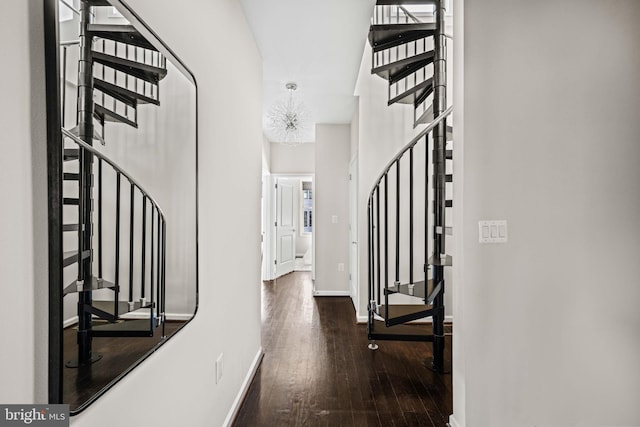 foyer with dark wood-style floors, baseboards, and stairs