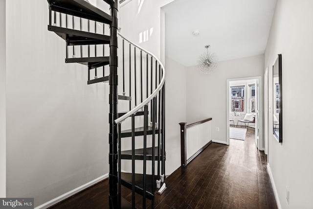 stairs with baseboards and wood finished floors