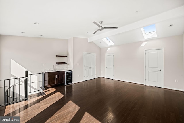 unfurnished living room with lofted ceiling, beverage cooler, dark wood-style flooring, a sink, and a ceiling fan