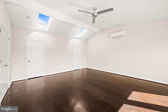 interior space with vaulted ceiling with skylight, baseboards, a ceiling fan, wood finished floors, and an AC wall unit