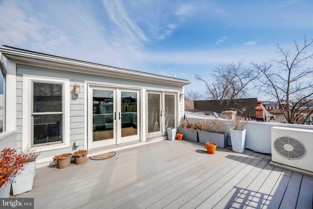 deck featuring french doors and ac unit