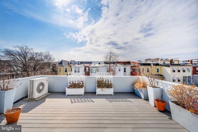 deck with ac unit and a residential view