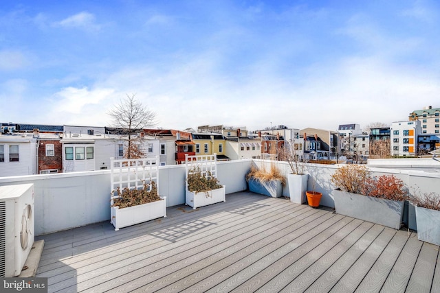 wooden deck with ac unit and a residential view