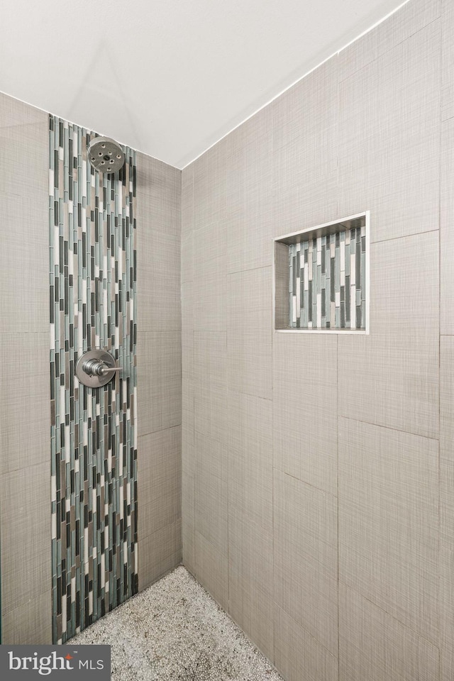 full bath with a tile shower