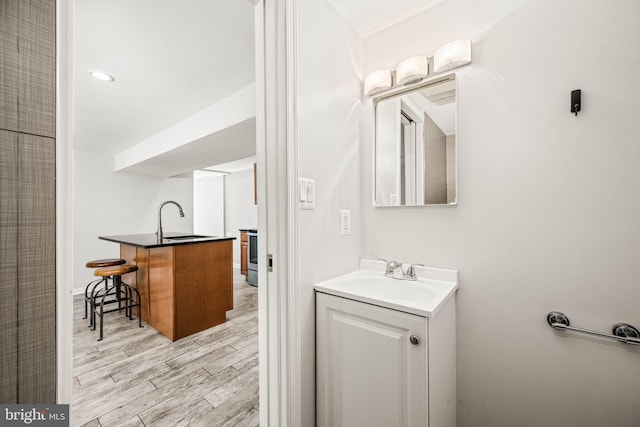 bathroom with vanity and wood finished floors