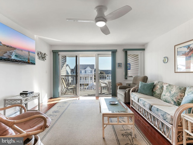 living area with ceiling fan and wood finished floors