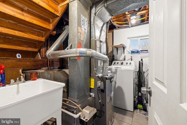 utilities featuring washer / clothes dryer and a sink