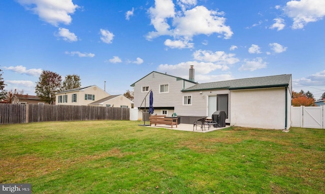 rear view of property with a patio area, a lawn, and a fenced backyard