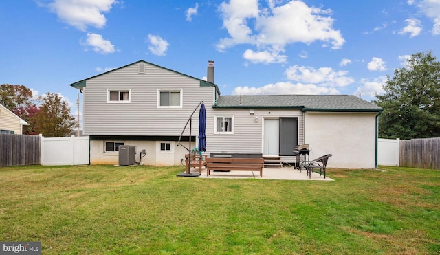 rear view of property featuring a fenced backyard, central AC, a lawn, and a patio