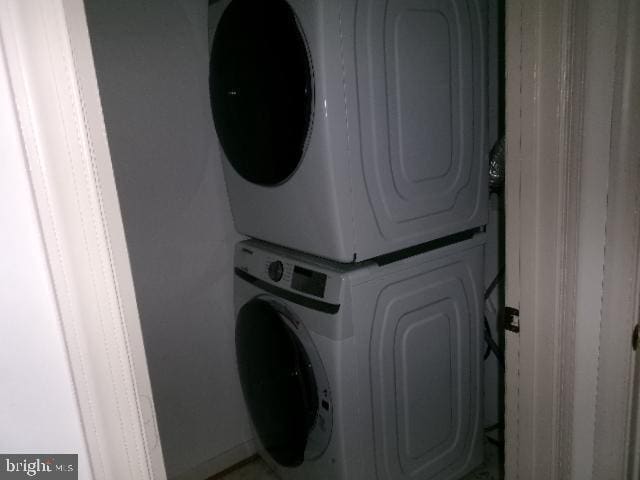 laundry area featuring stacked washer and dryer and laundry area