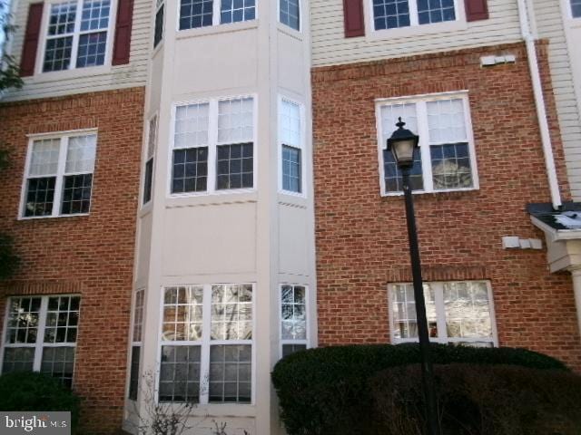 view of side of property with brick siding