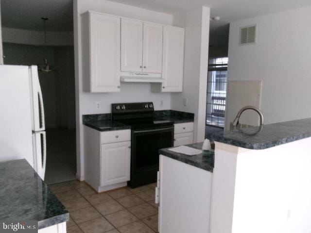 kitchen with black electric range, visible vents, freestanding refrigerator, white cabinetry, and under cabinet range hood