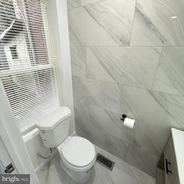 bathroom with toilet and visible vents