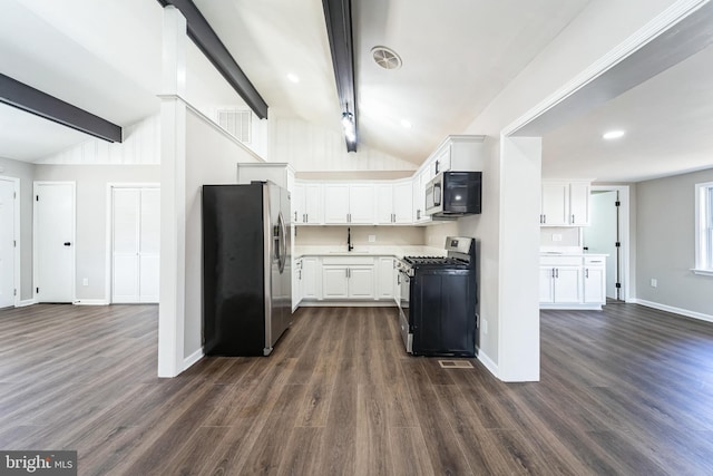 kitchen featuring white cabinetry, dark wood-type flooring, vaulted ceiling with beams, and stainless steel appliances