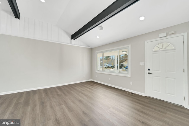 foyer featuring baseboards, wood finished floors, and vaulted ceiling with beams