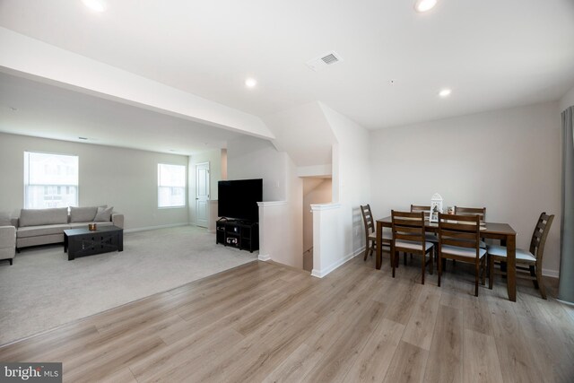 dining room featuring baseboards, light wood-style flooring, visible vents, and recessed lighting