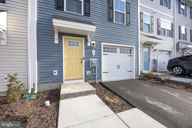 doorway to property featuring a residential view and a garage