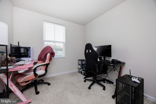 carpeted home office featuring baseboards and lofted ceiling