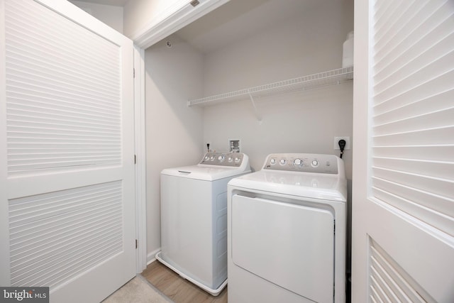 clothes washing area with washer and dryer and laundry area