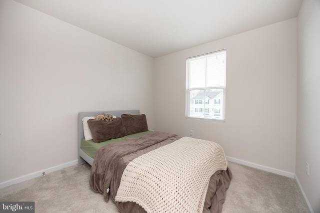 bedroom featuring baseboards and carpet flooring