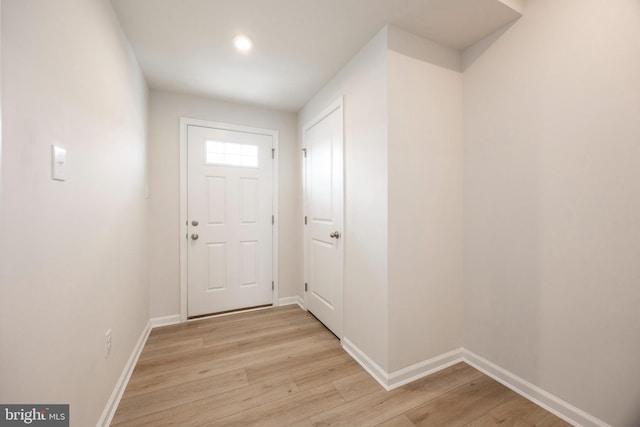 entryway featuring light wood finished floors and baseboards