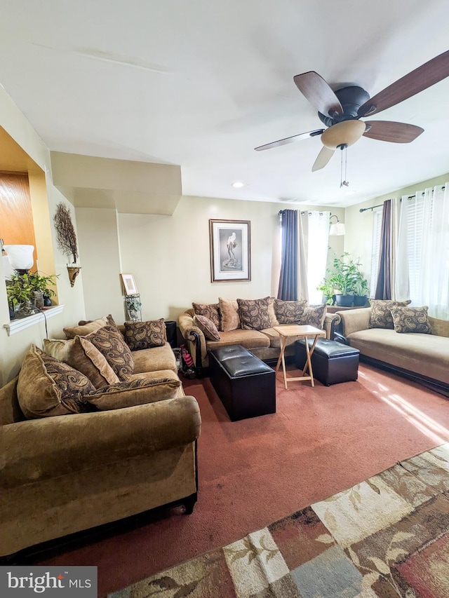 living area with carpet flooring and a ceiling fan