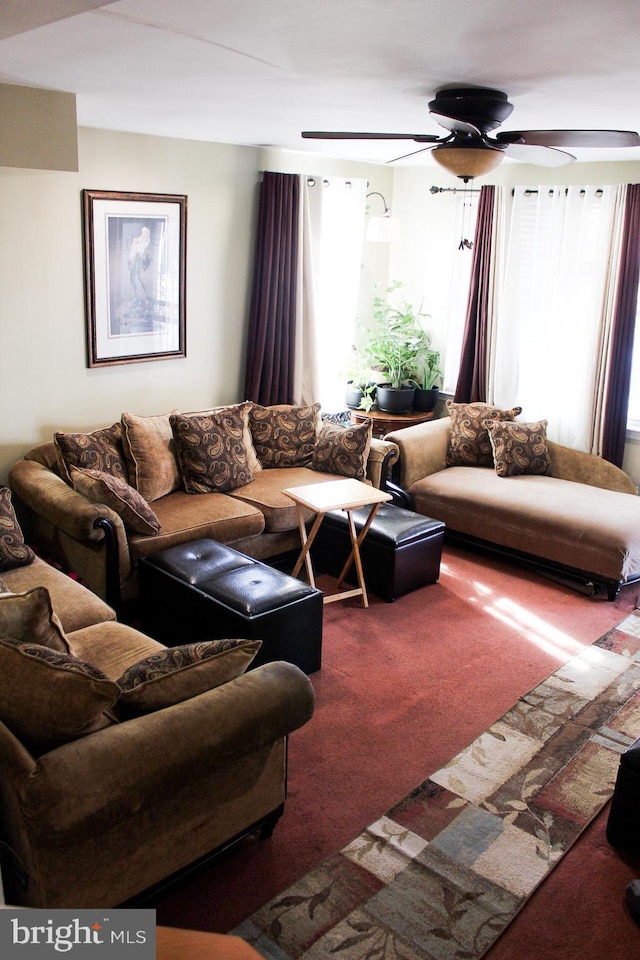 carpeted living area featuring ceiling fan