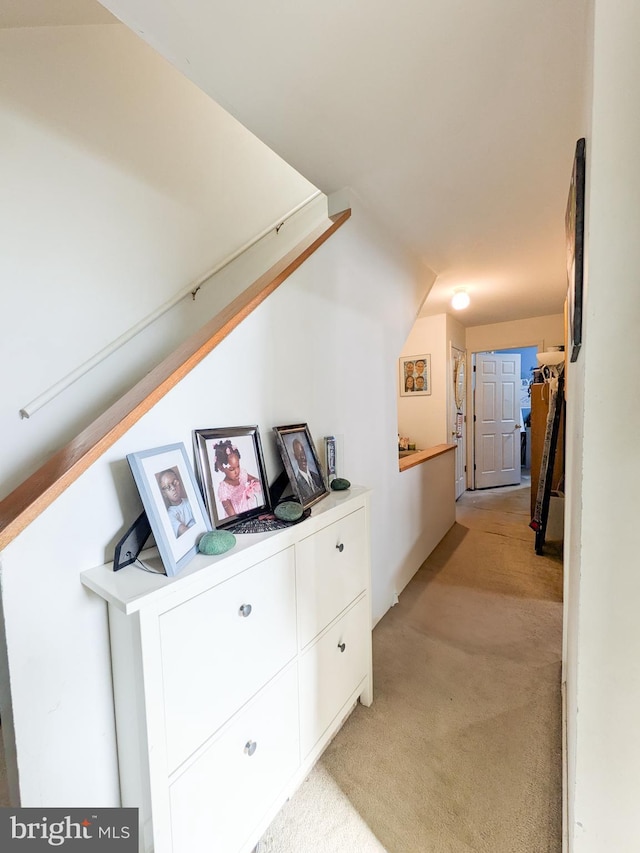 hall featuring light colored carpet