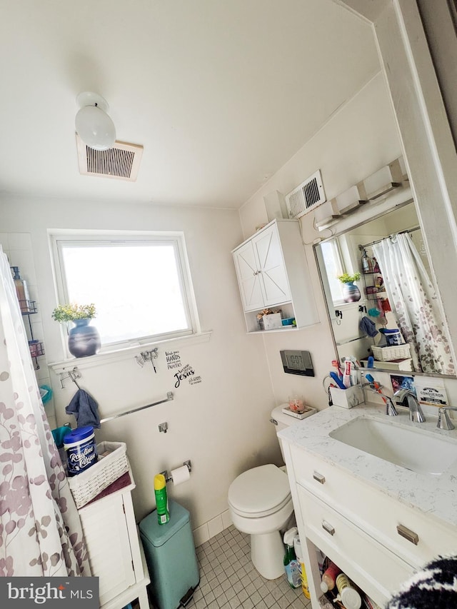 bathroom featuring toilet, tile patterned flooring, vanity, and visible vents