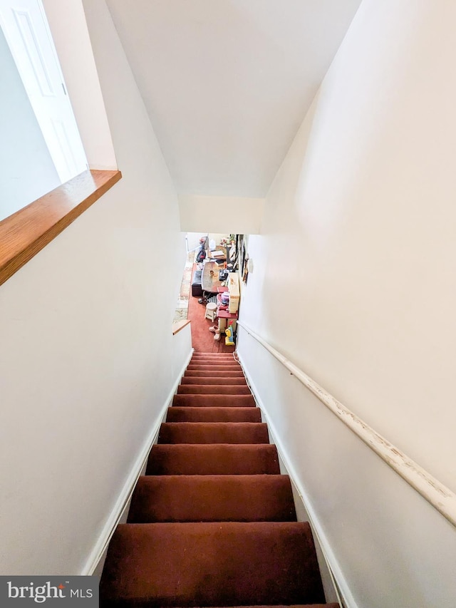 staircase featuring baseboards