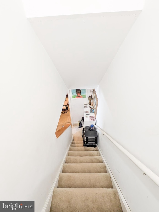 stairs featuring carpet and baseboards