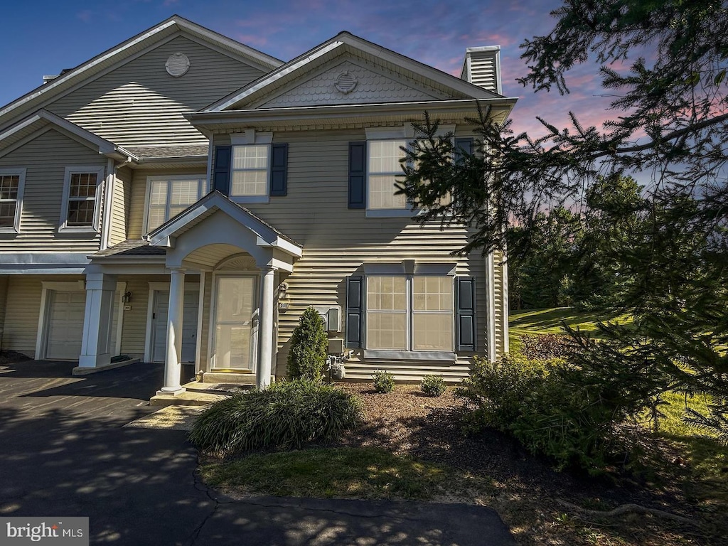 view of front of property featuring aphalt driveway and an attached garage