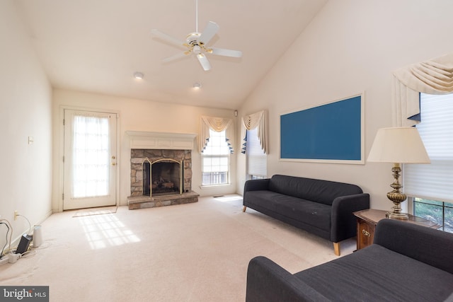 living room with carpet flooring, a stone fireplace, ceiling fan, and high vaulted ceiling