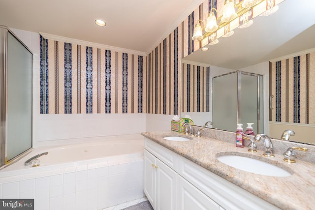 full bathroom featuring a sink, a garden tub, a stall shower, and wallpapered walls