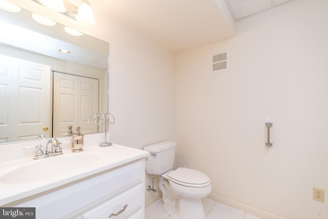 bathroom featuring visible vents, baseboards, toilet, tile patterned floors, and vanity