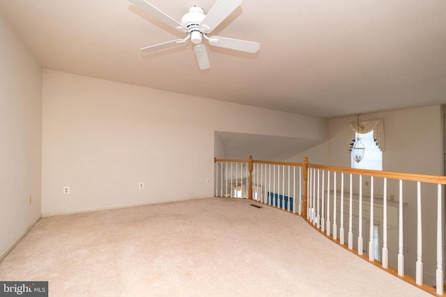 carpeted empty room with visible vents and ceiling fan