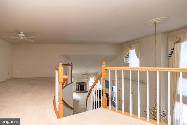 interior space with carpet and an upstairs landing