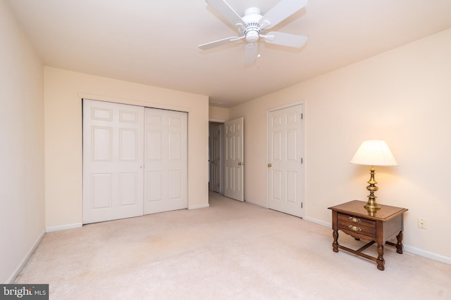 bedroom with ceiling fan, baseboards, a closet, and light carpet