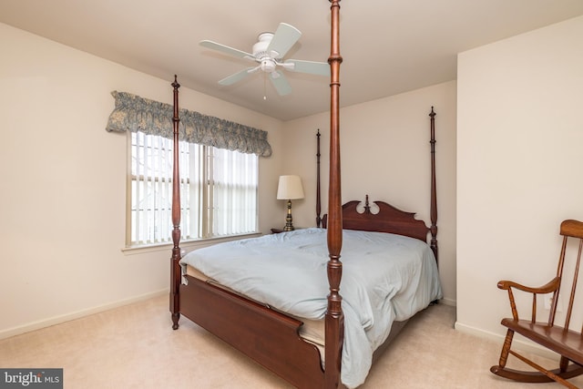 bedroom with a ceiling fan, light colored carpet, and baseboards