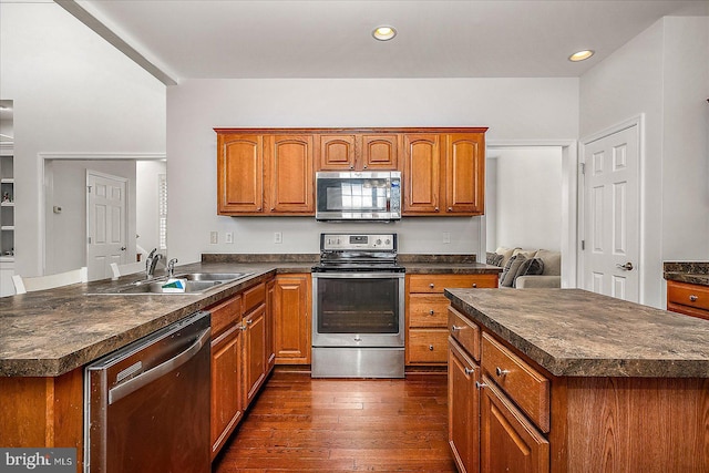 kitchen with dark countertops, stainless steel appliances, and a sink