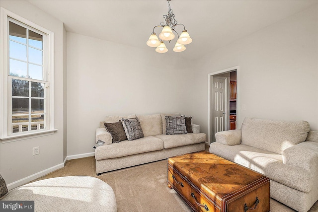 living room with carpet floors, plenty of natural light, an inviting chandelier, and baseboards