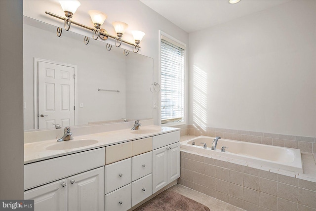 bathroom featuring double vanity, tile patterned floors, a sink, and a bath