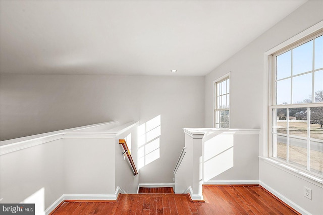 stairs featuring baseboards and hardwood / wood-style floors