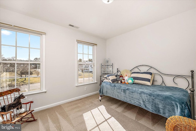 bedroom with light carpet, baseboards, and visible vents