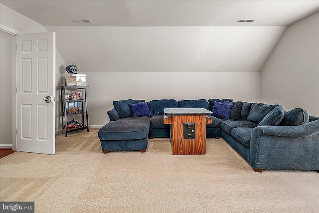 living area featuring lofted ceiling, visible vents, and light carpet