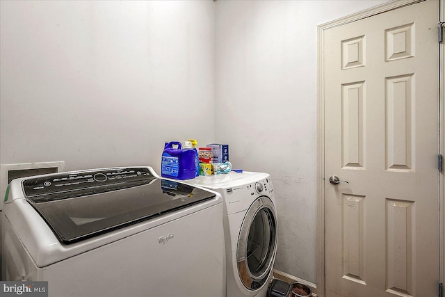 clothes washing area with laundry area and washer and dryer