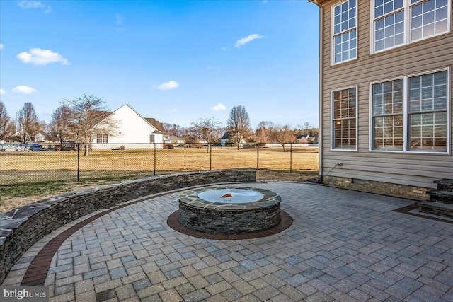 view of patio with fence and a fire pit